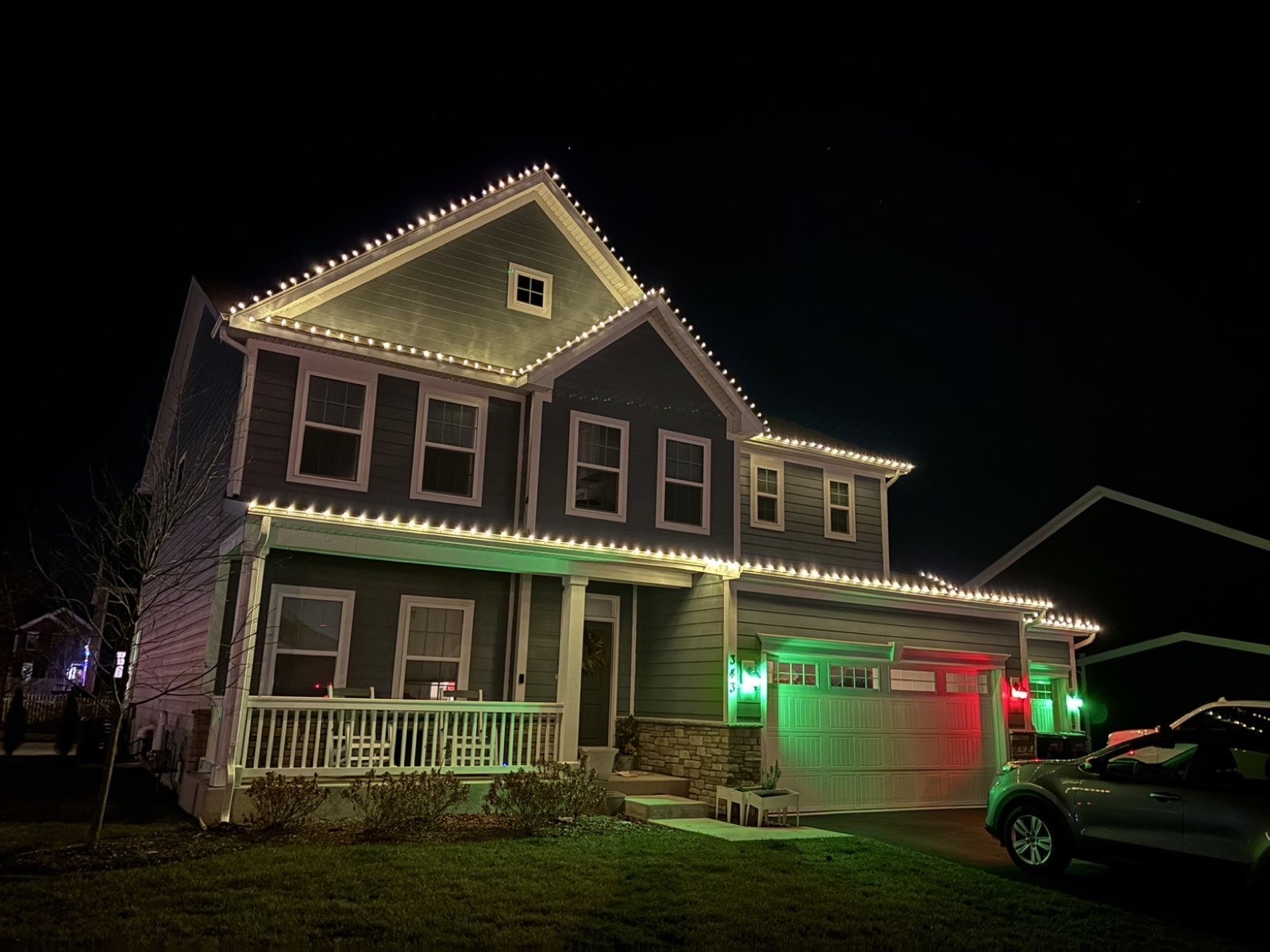 Christmas lights installed on a roofline